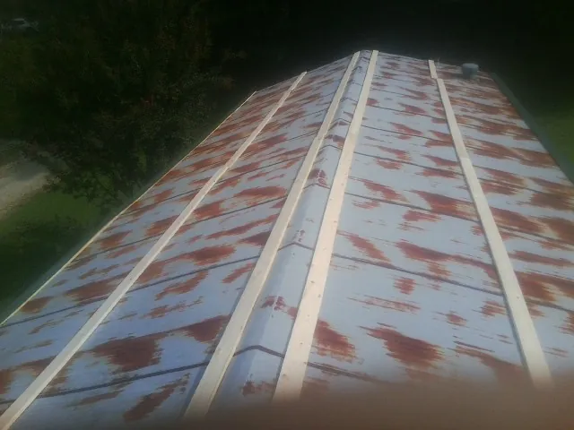 Rusted metal roof panels with new wood purlins before replacement — Storm Damage Roof Repair in Pico Rivera by Roofing Brothers